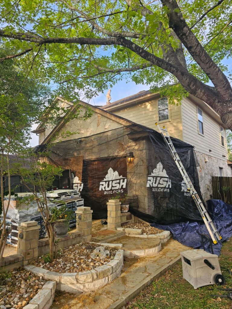 Rush Builders branded protective tarps on an Austin home during roof replacement