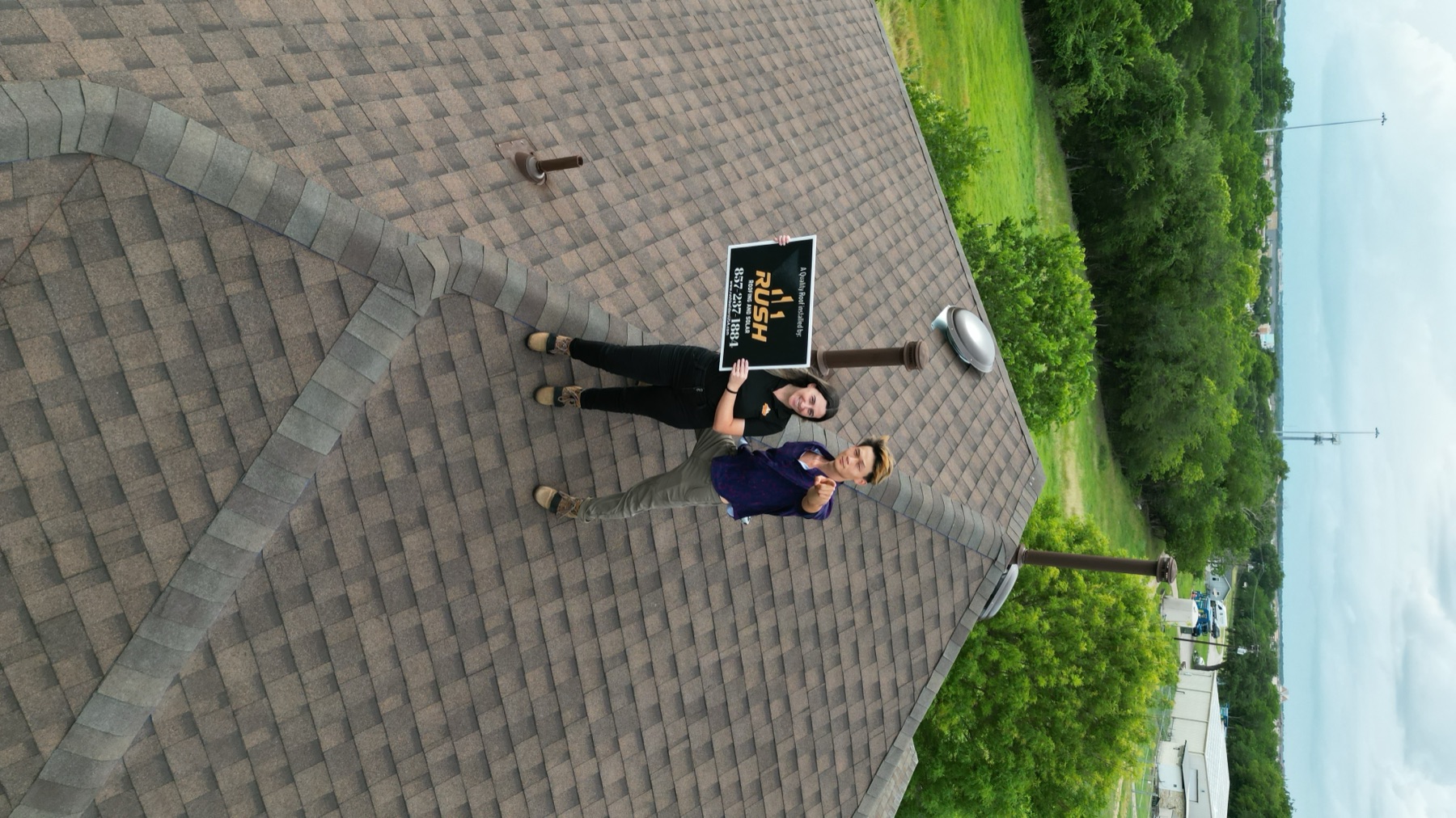 Robinson and Paula, founders of Rush Builders Roofing and Solar, on a completed Austin roof